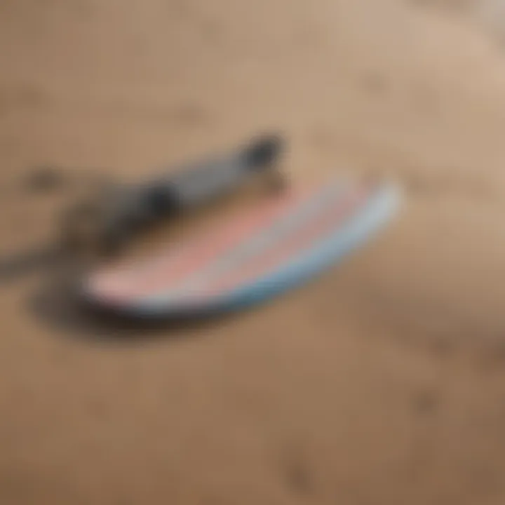 Close-up of high-quality skimboarding equipment laid out on the sand