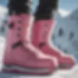 Stylish pink snowboard boots on a snowy slope