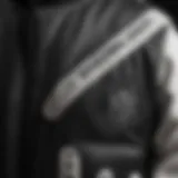 A close-up of the intricate design of a black and white varsity jacket, showcasing its unique fabric and stitching details.