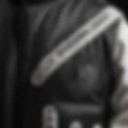 A close-up of the intricate design of a black and white varsity jacket, showcasing its unique fabric and stitching details.