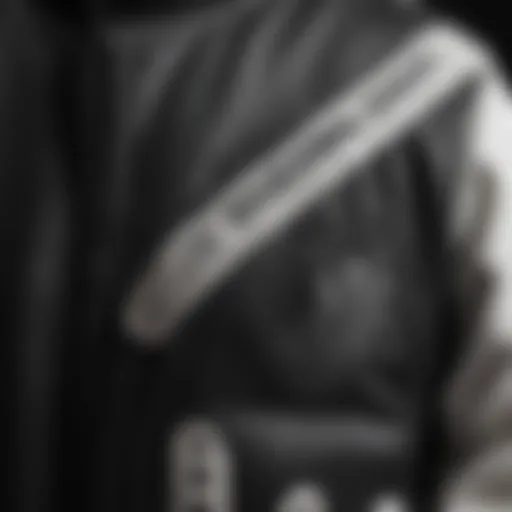 A close-up of the intricate design of a black and white varsity jacket, showcasing its unique fabric and stitching details.