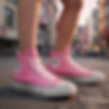 A stylish individual wearing Chuck Taylor All Star Pink High Tops in an urban setting