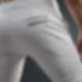 Close-up view of white running pants showcasing breathable fabric and design features.