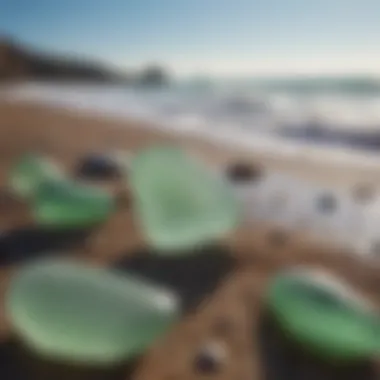 Close-up of various shapes and sizes of sea glass against a backdrop of ocean waves