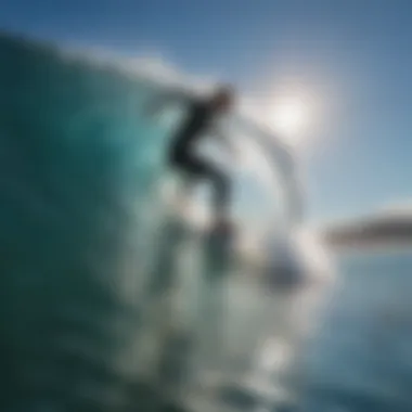 A surfer riding a powerful wave under a clear blue sky