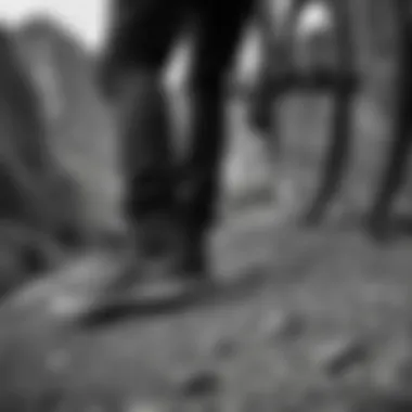 Close-up of black and white Vans footwear on a mountain biker's feet, illustrating functionality.