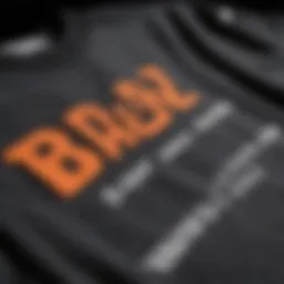 Close-up of the 'by any means' shirt design showcasing its bold typography.