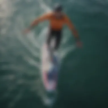Rider in Motion An aerial view of a rider gliding effortlessly over the water on a foil board.