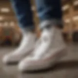 Stylish white Converse size 2 sneakers resting on a skateboard