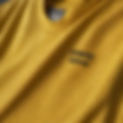 Close-up view of the yellow Reebok shirt showcasing its fabric texture.