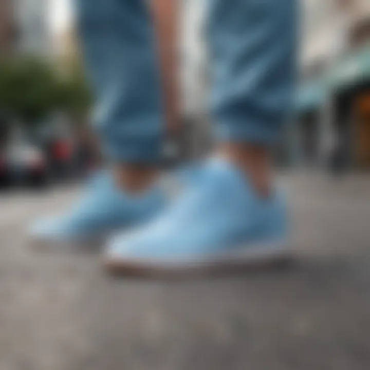 Trendy street style featuring individuals wearing light blue Nike sneakers in urban environment