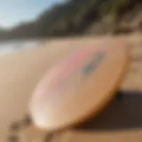 A variety of skimboards displayed on a sandy beach