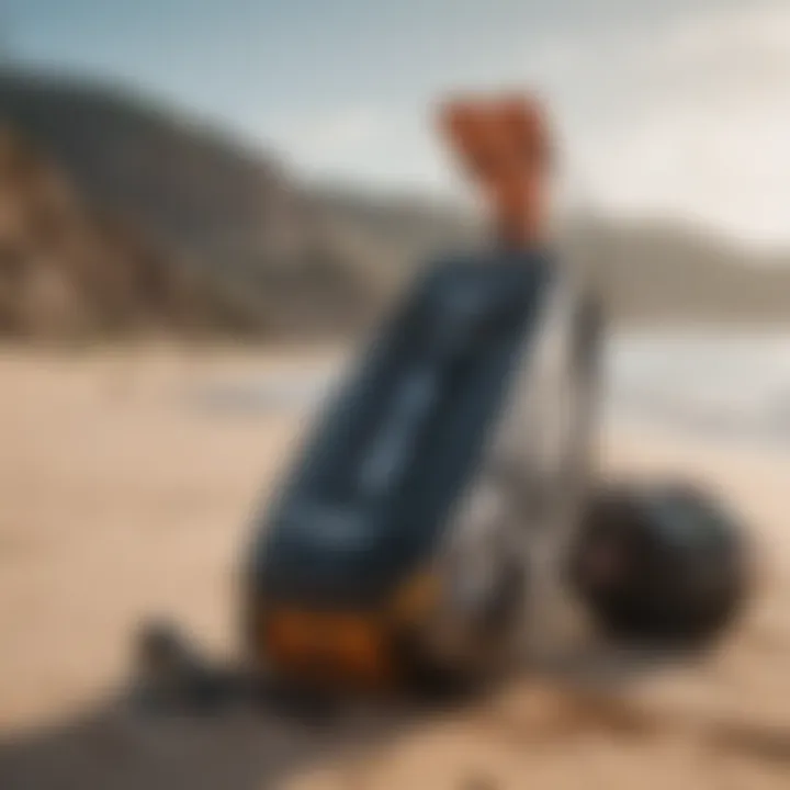 A Slingshot wakeboard bag beside a wakeboard on a sandy beach