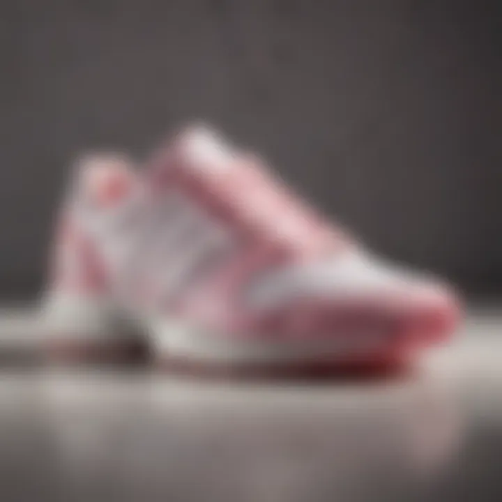 A close-up view of adidas footwear showcasing the white and pink color scheme, highlighting its elegant design.