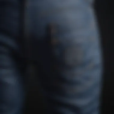 Close-up detailing of dark blue biker jeans showcasing stitching and texture