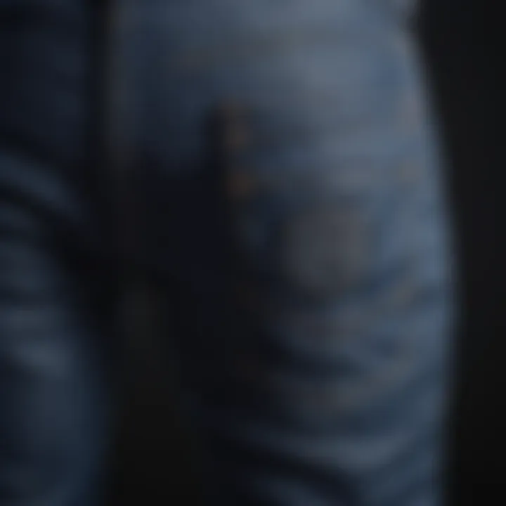 Close-up detailing of dark blue biker jeans showcasing stitching and texture