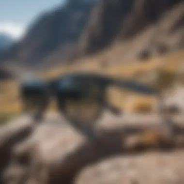 Close-up view of grey wayfarer sunglasses on a rocky mountain backdrop.