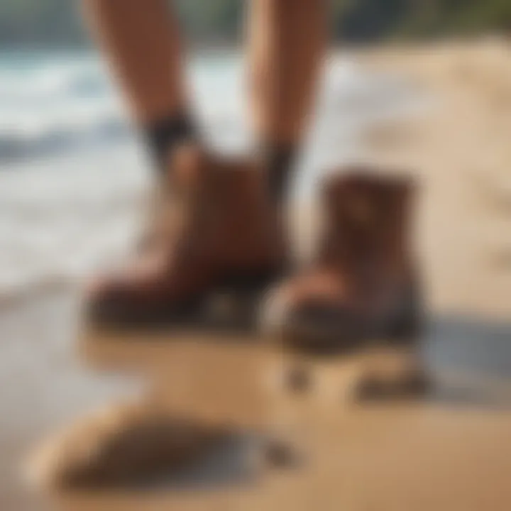 A pair of reef booties placed on a sandy beach with ocean waves in the background