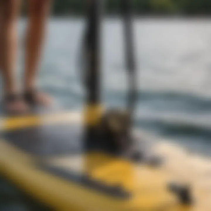 Close-up of a SUP pump adapter in use on a stand-up paddleboard.